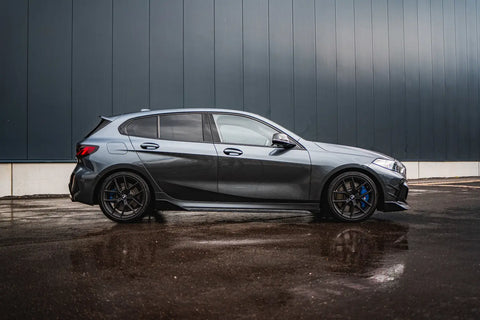 Sleek grey BMW 1-Series hatchback with black wheels showcasing Masata lowering springs.
